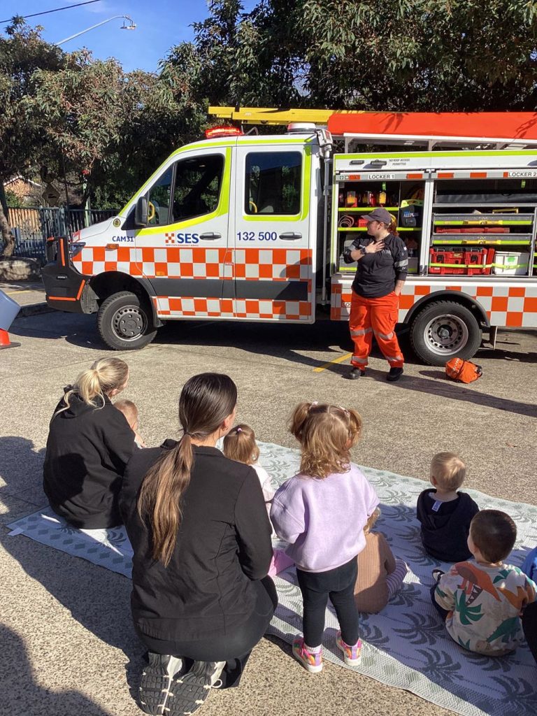Children and educators looking at an SES truck outside Macarthur Early Learning