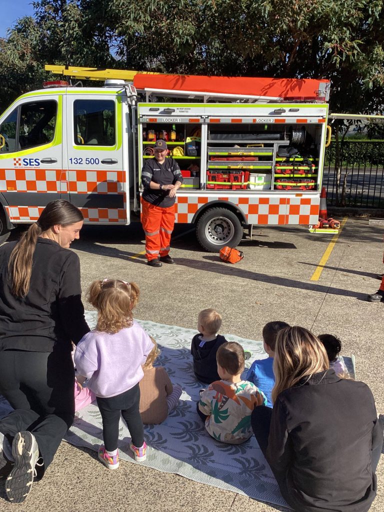 Families and children watching an SES crew during a visit to Macarthur Early Learning