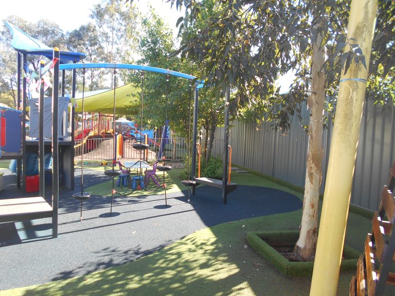 Children playing in the outdoor playground at Macarthur Early Learning