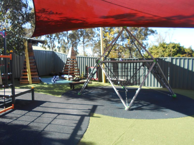 Children playing in the outdoor playground at Macarthur Early Learning